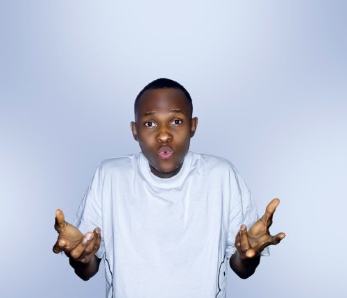 A young boy raising his hands